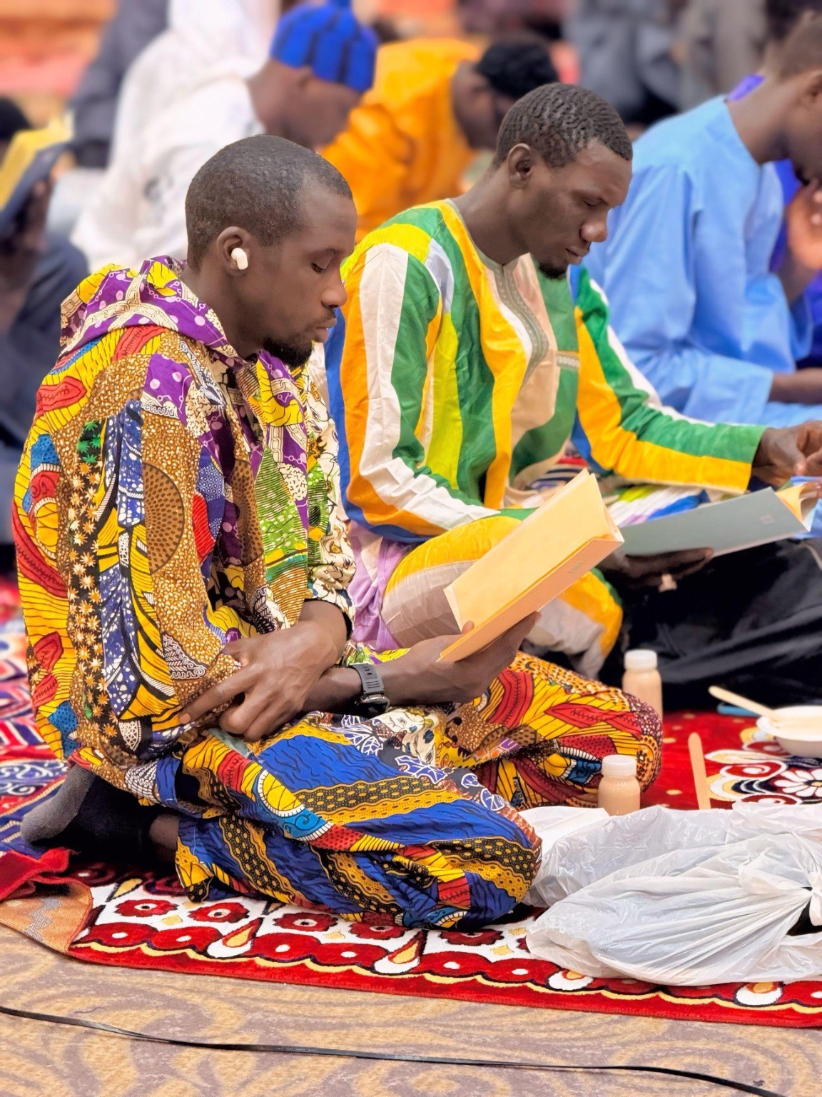 Attendees reading during the Magal
